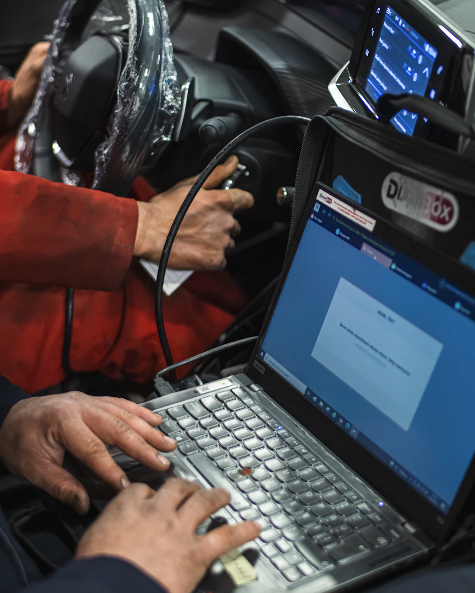 Diagnostic laptop plugged into a car